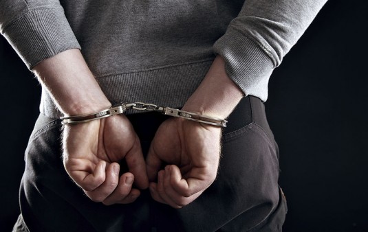 Man's Hands Locked in Handcuffs