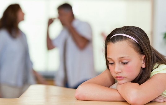 Sad girl with her fighting parents