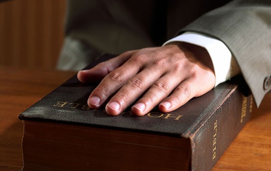 Hand on bible, swearing in