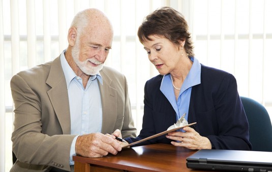Senior reviewing will with lawyer